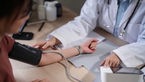 Doctor checking a patient’s blood pressure during a medical consultation